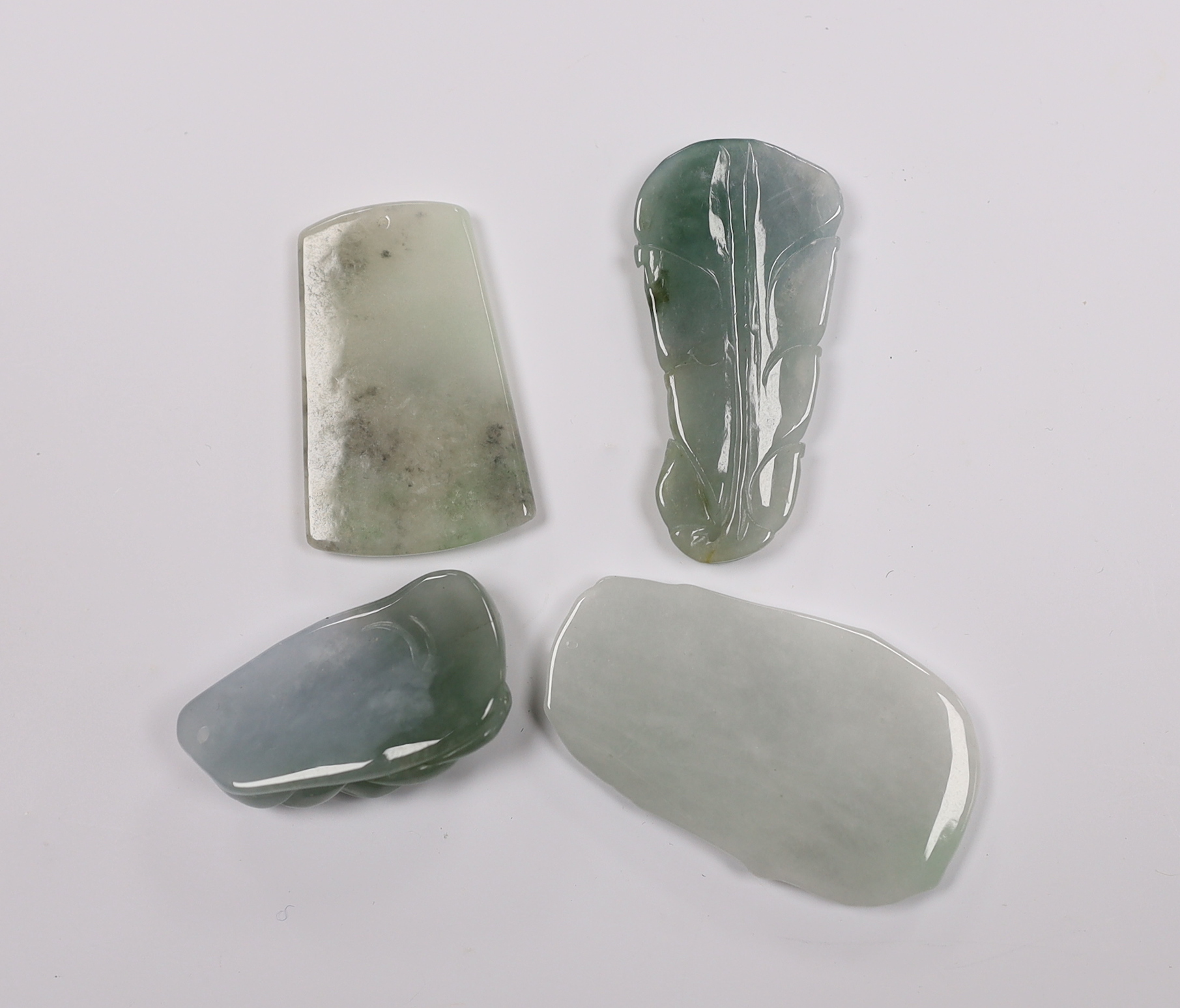 Four Chinese carved jadeite pendants